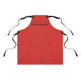 It's a Condiment Ketchup Apron - Image of ketchup colored red apron with saying It's not dog hair it's a condiment with an outline of a condiment with 4 black ties attached to the red apron with black buttons on a white background. 