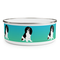 Cavalier King Charles Spaniel Enamel Bowl – Image description – White enamel bowl with a blue fading into green stripe with a Cavalier King Charles Spaniel sitting in the middle of the stripe. The dog has a black head and white body with his head slightly tilted. This dog is spaced out on the bowl and is visible in 3 places in this image. The top of the bowl has a silver rim. 