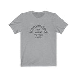 Introverted But Willing to Talk Dogs Tee - Image Description - Athletic Heather Grey t-shirt with Introverted in an arch in grey text, and But Willing To Talk Dogs underneath the arch in black text.