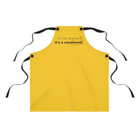 It's a Condiment Mustard Apron - Image description - mustard colored yellow apron with saying It's not dog hair it's a condiment with an outline of a condiment with 4 black ties attached to the red apron with black buttons on a white background. 