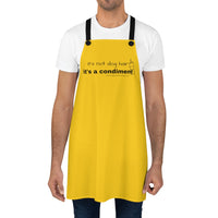 It's a Condiment Mustard Apron - Image description - a male wearing a white t-shirt, jeans and the mustard colored yellow apron with saying It's not dog hair it's a condiment with an outline of a condiment bottle.